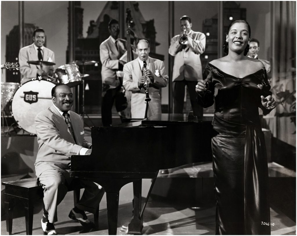 Film still features American jazz musician Count Basie (1904 - 1984) and singer Billie Holiday (1915 - 1959) in a Universal International musical short, 1951. (Photo by John D. Kisch/Separate Cinema Archive/Getty Images)